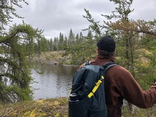 Tour guide hiking by a river